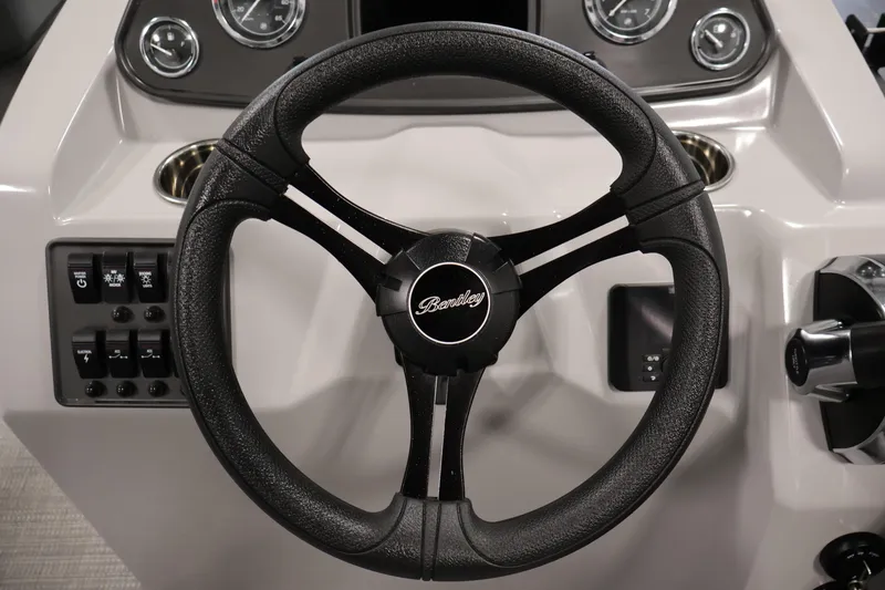 Slide: The Image of Steering wheel of 2026 Bentley Pontoons 160 Cruise LE with dashboard controls. - 19