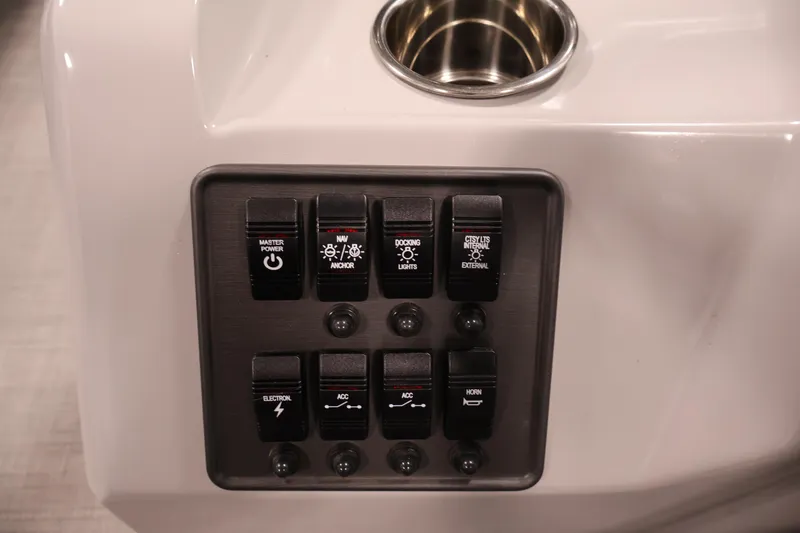 Slide: The Image of Control panel of 2026 Bentley Pontoons 160 Cruise LE with various switches and cup holder. - 21