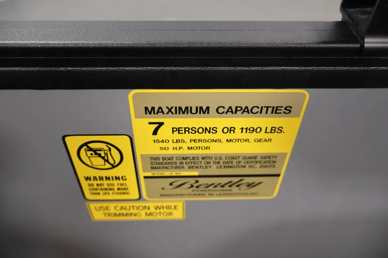 Slide: The Image of Yellow capacity label on 2026 Bentley Pontoons 160 Cruise LE, indicating 7-person limit. - 23