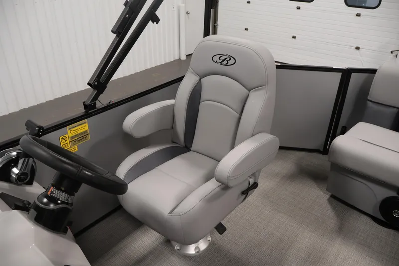 Slide: The Image of 2026 Bentley Pontoons 160 Cruise LE interior with luxurious captain's chair and steering wheel. - 24