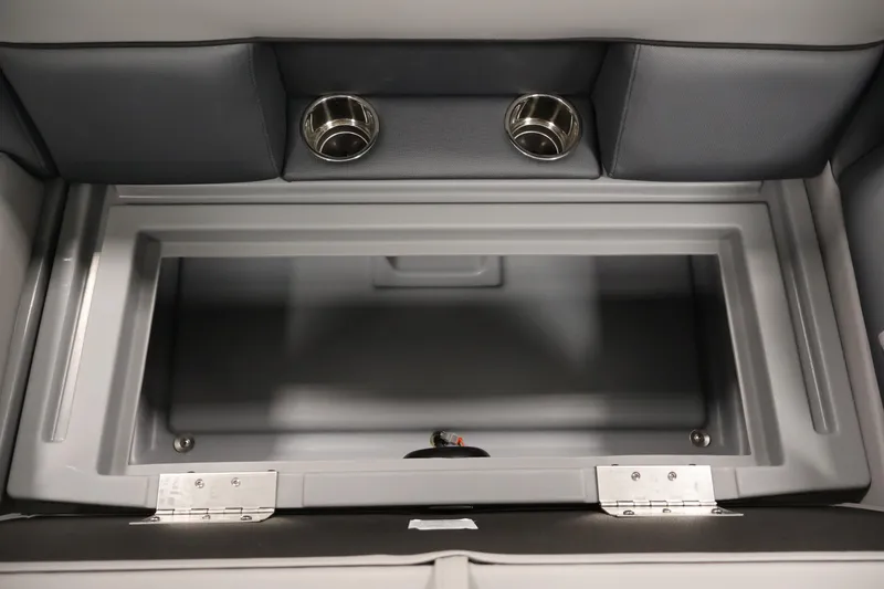 Slide: The Image of 2026 Bentley Pontoons 160 Cruise LE storage compartment with dual cup holders. - 27