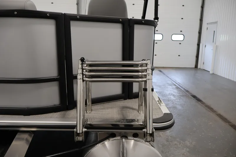 Slide: The Image of 2026 Bentley Pontoons 160 Cruise LE with stainless steel ladder in a garage setting. - 30