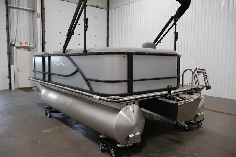 Slide: The Image of 2026 Bentley Pontoons 160 Cruise LE in a showroom, showcasing sleek design and modern features. - 6