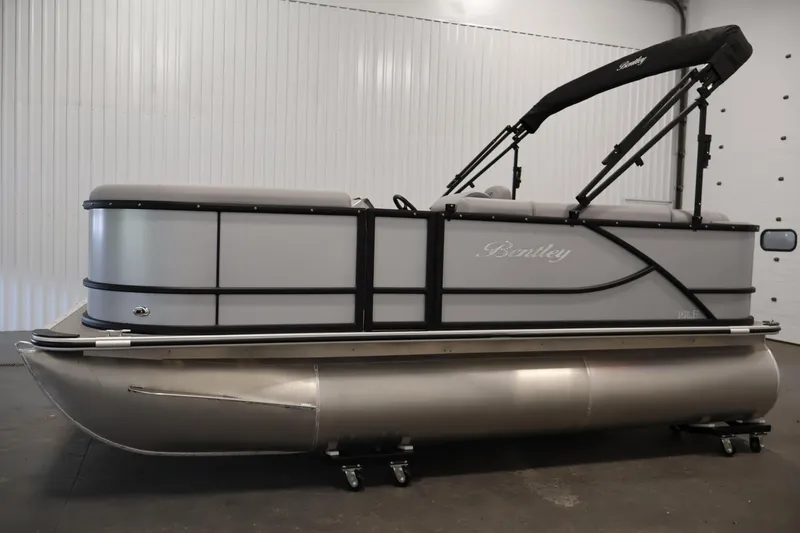Slide: The Image of 2026 Bentley Pontoons 160 Cruise LE in a showroom, showcasing sleek design and modern features. - 7