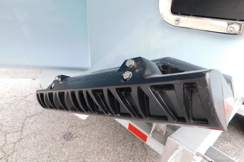 Slide: The Image of 2026 Regulator 28 boat detail showing black trim tab on trailer. - 12