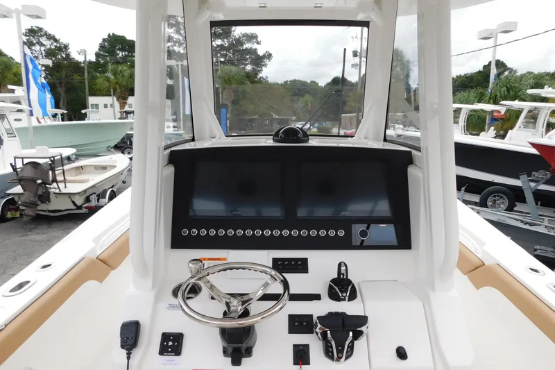 Slide: The Image of 2026 Regulator 28 boat dashboard with dual screens and steering wheel. - 15