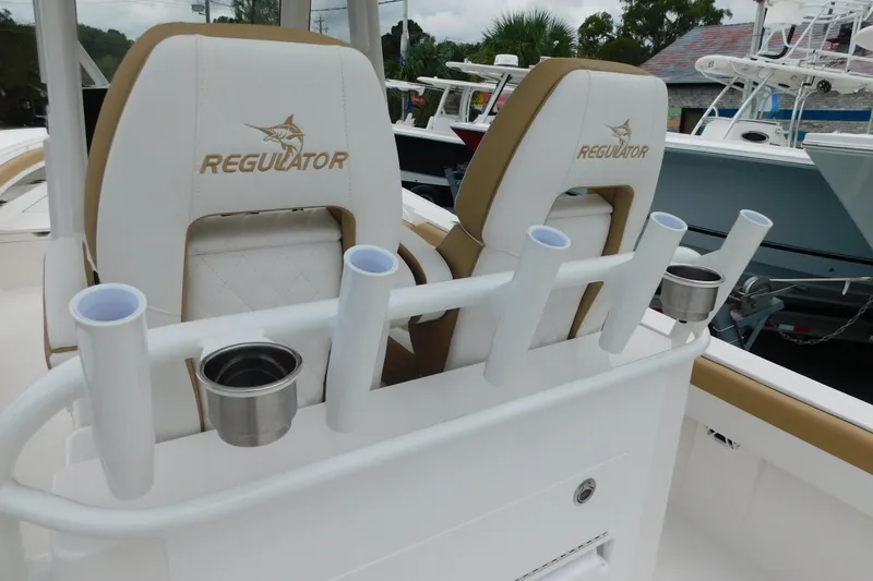 Slide: The Image of 2026 Regulator 28 boat seats with rod holders and cup holders. - 16