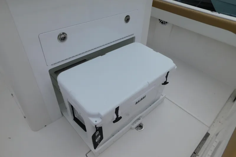 Slide: The Image of White cooler on 2026 Regulator 28 boat deck, near storage compartment. - 18
