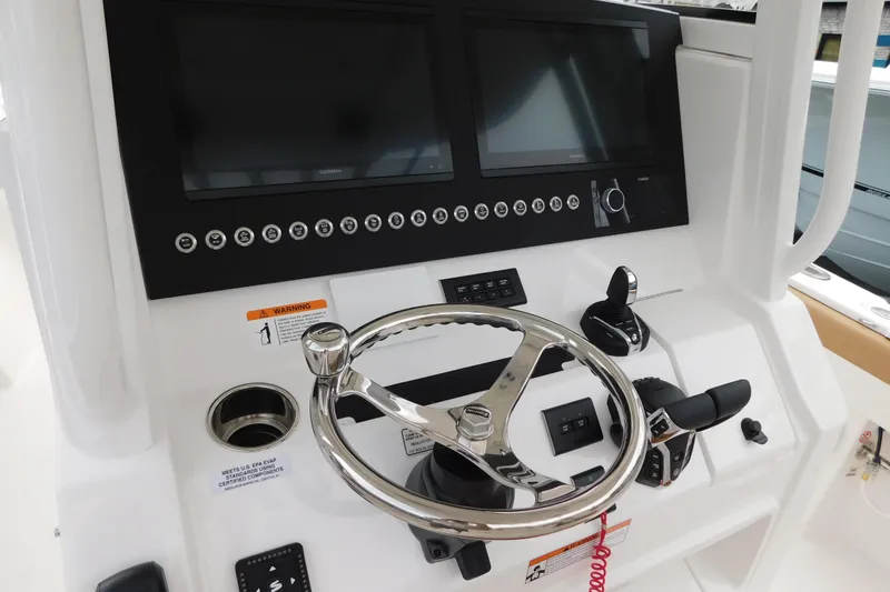 Slide: The Image of 2026 Regulator 28 boat dashboard with dual screens and steering wheel. - 2
