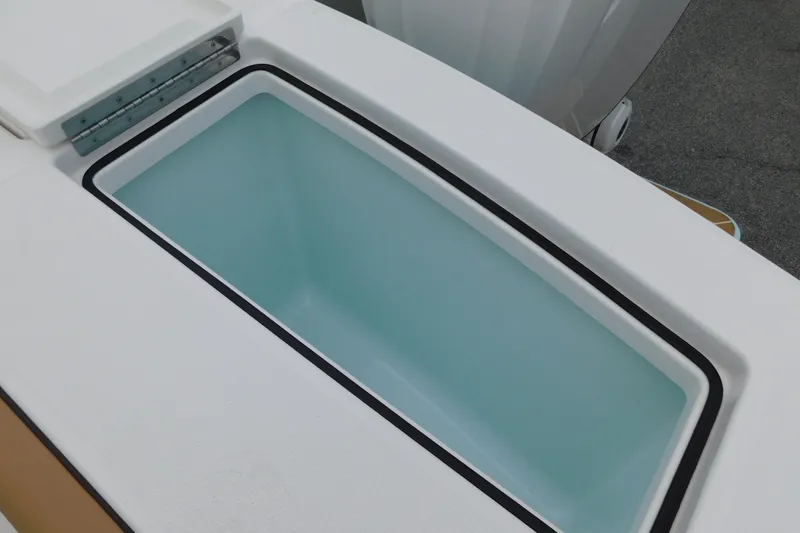 Slide: The Image of 2026 Regulator 28 boat storage compartment with open lid, showcasing interior design. - 23
