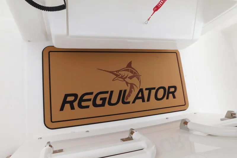Slide: The Image of 2026 Regulator 28 boat logo with marlin design on a tan background. - 27