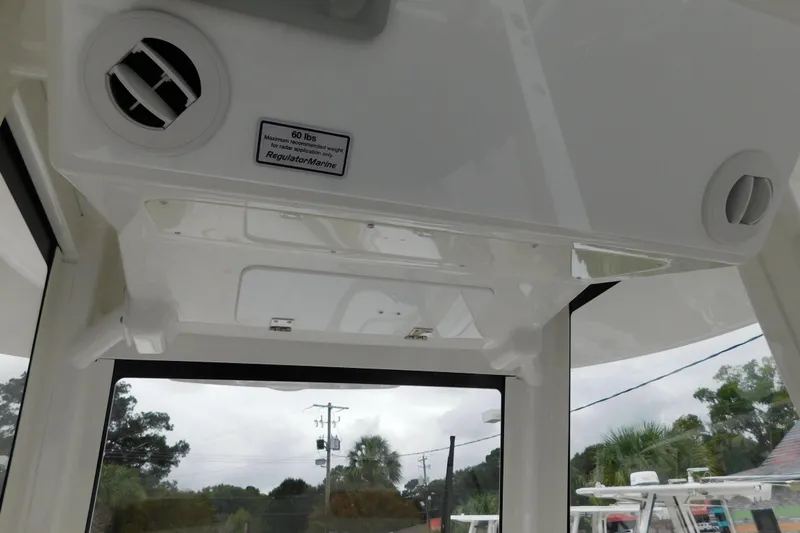 Slide: The Image of Interior view of a 2026 Regulator 28 boat, featuring air vents and a weight limit sign. - 40