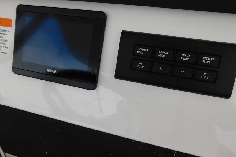 Slide: The Image of Control panel of a 2026 Regulator 28 boat with Yamaha display and navigation buttons. - 45