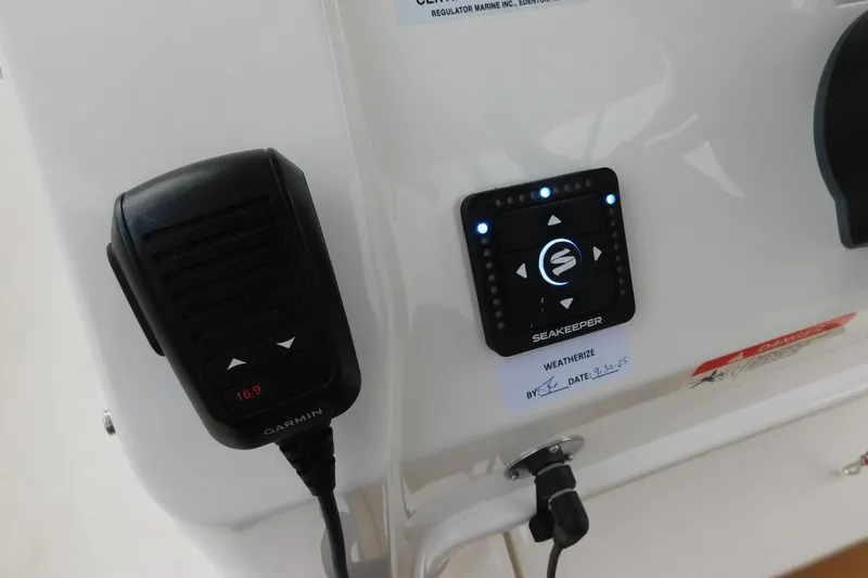 Slide: The Image of 2026 Regulator 28 boat console with Garmin radio and Seakeeper control panel. - 47