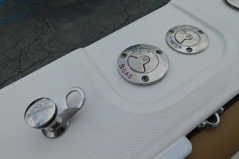 Slide: The Image of 2026 Regulator 28 boat fuel and water caps on deck. - 48