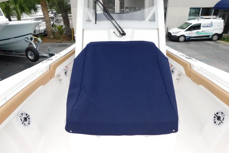 Slide: The Image of 2026 Regulator 28 boat interior with blue cover and tan accents. - 49