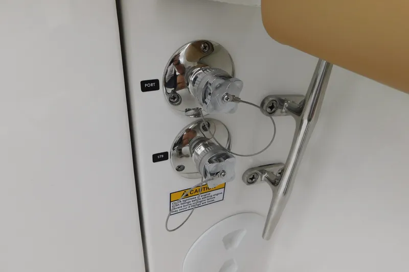 Slide: The Image of 2026 Regulator 28 boat controls with port and starboard labels, safety cables attached. - 51