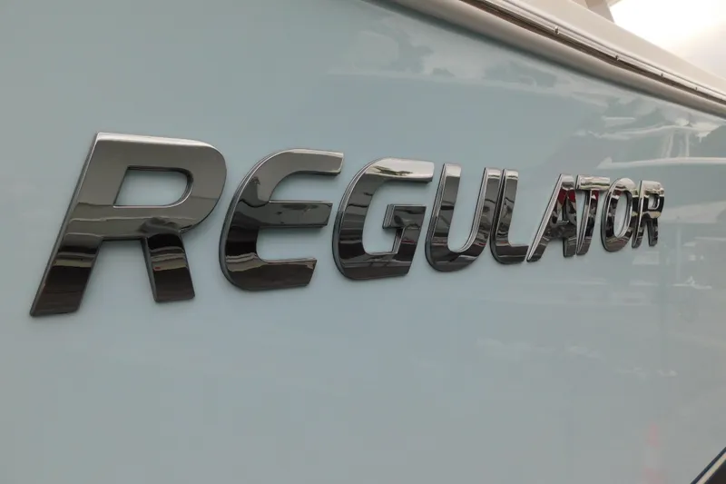 Slide: The Image of Regulator 28 boat logo, 2026 model, chrome lettering on hull. - 57