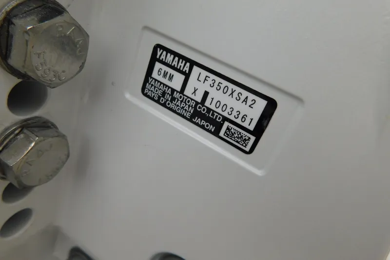 Slide: The Image of Label on Yamaha motor, model LF350XSA2, made in Japan, with bolts visible. - 58