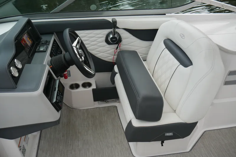 Slide: The Image of 2019 Regal 26 FasDeck boat interior with luxurious seating and modern dashboard controls. - 10