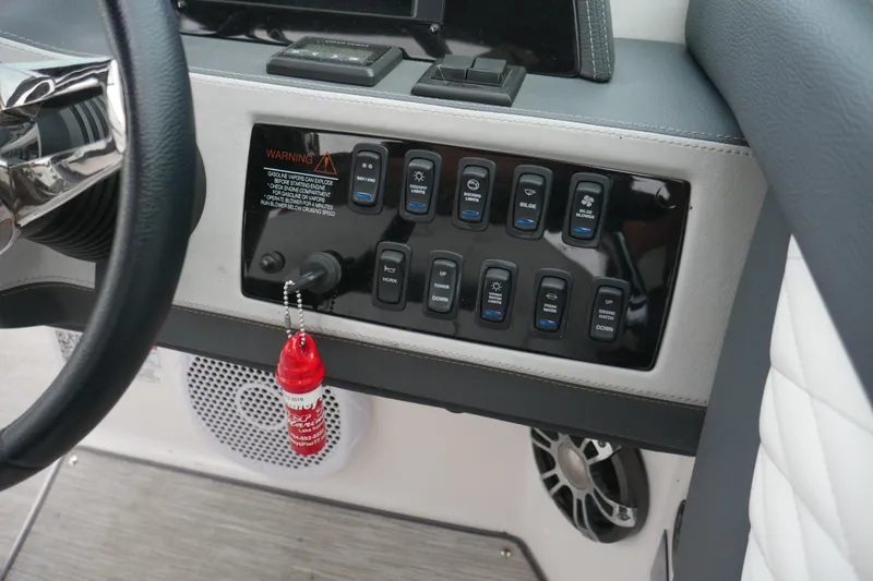 Slide: The Image of Control panel of 2019 Regal 26 FasDeck boat with switches and warning label. - 11