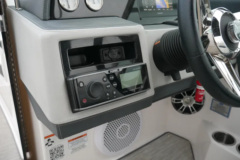 Slide: The Image of 2019 Regal 26 FasDeck boat dashboard with Fusion stereo system and steering wheel. - 12