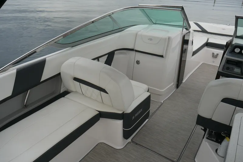 Slide: The Image of 2019 Regal 26 FasDeck boat interior with white seating and modern design. - 13