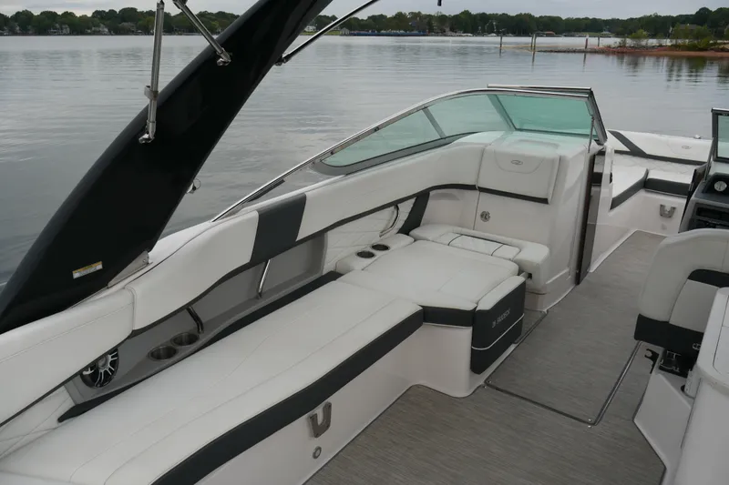 Slide: The Image of 2019 Regal 26 FasDeck boat interior with sleek seating and modern design on a calm lake. - 14