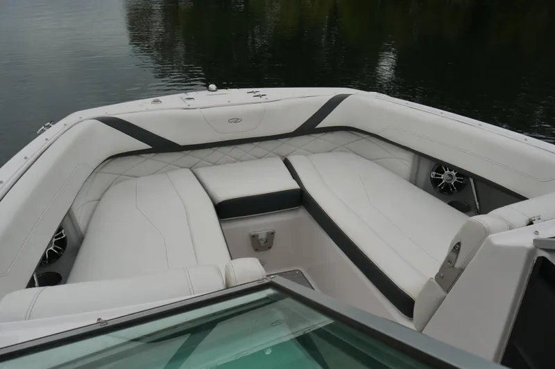 Slide: The Image of Luxurious interior of 2019 Regal 26 FasDeck boat with white seating and water view. - 19