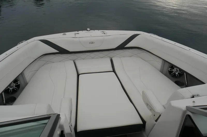 Slide: The Image of 2019 Regal 26 FasDeck boat interior with white cushioned seating and speakers. - 21