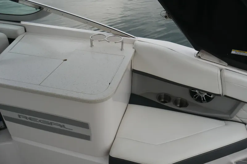 Slide: The Image of 2019 Regal 26 FasDeck boat interior with seating and cup holders. - 26