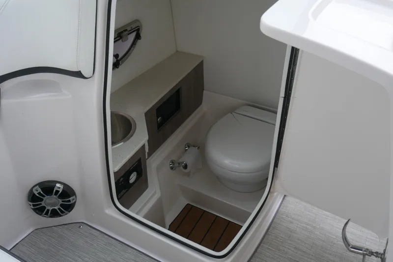 Slide: The Image of 2019 Regal 26 FasDeck boat interior bathroom with sink and toilet. - 28