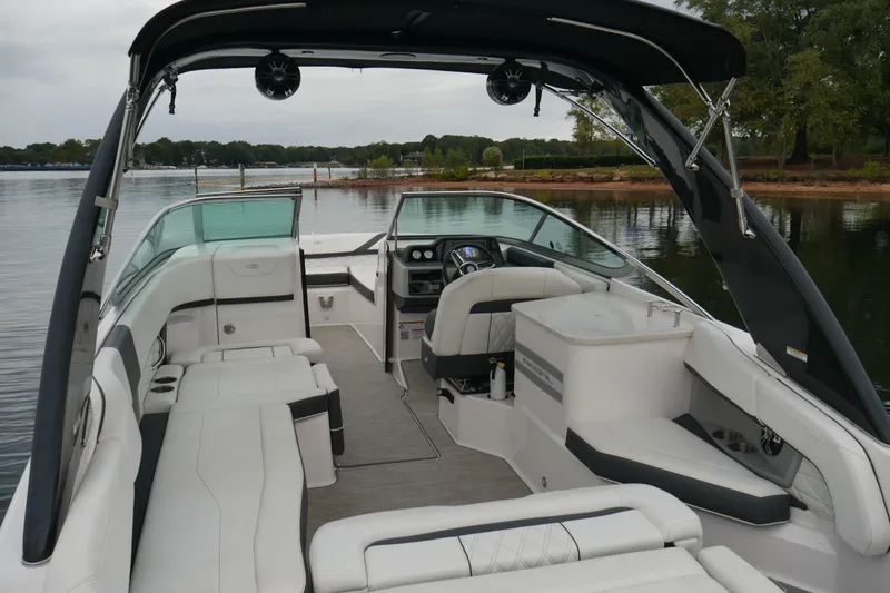 Slide: The Image of 2019 Regal 26 FasDeck boat interior with spacious seating and modern design on a calm lake. - 8