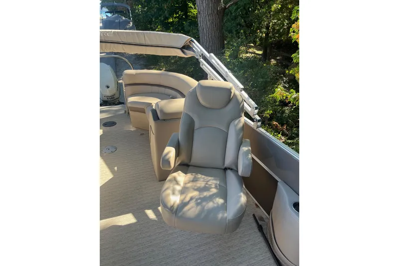 Slide: The Image of 2018 Berkshire 22 Quad Bench Tritoon with comfortable seating and lush greenery background. - 3