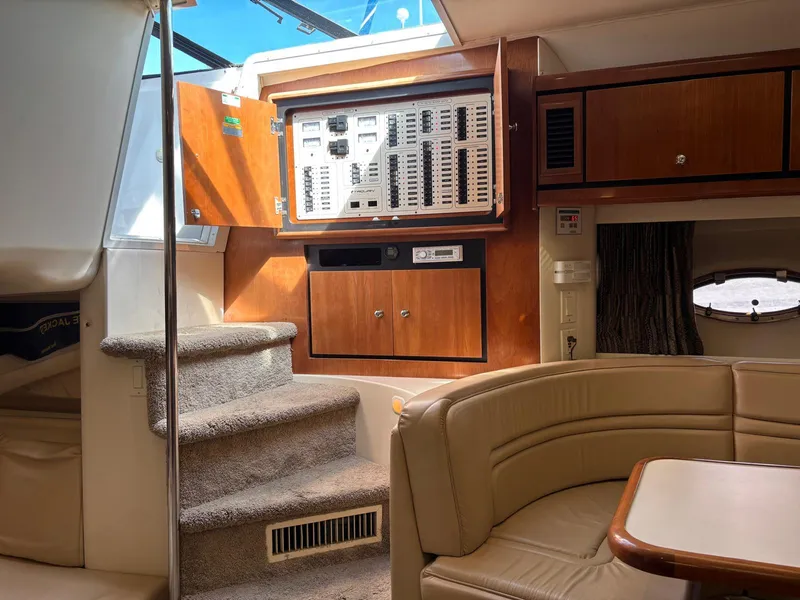 Slide: The Image of Interior of a 1998 Trojan 400 yacht with control panel and seating area. - 13