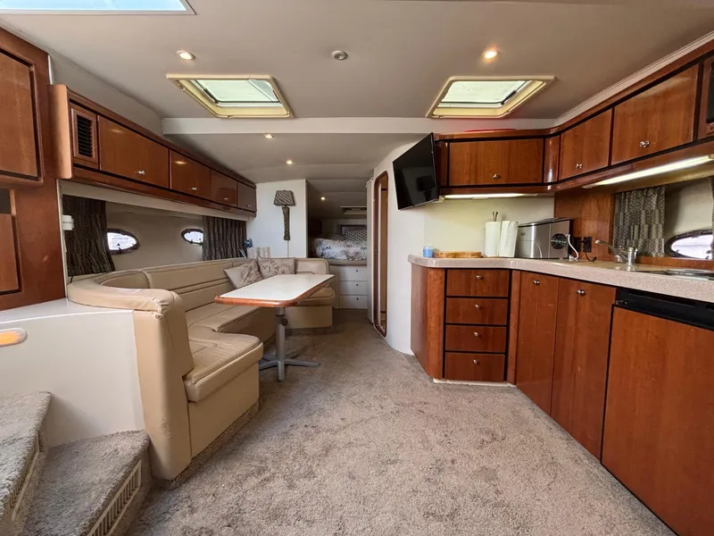 Slide: The Image of Luxurious interior of a 1998 Trojan 400 yacht with elegant wood cabinetry and plush seating. - 14
