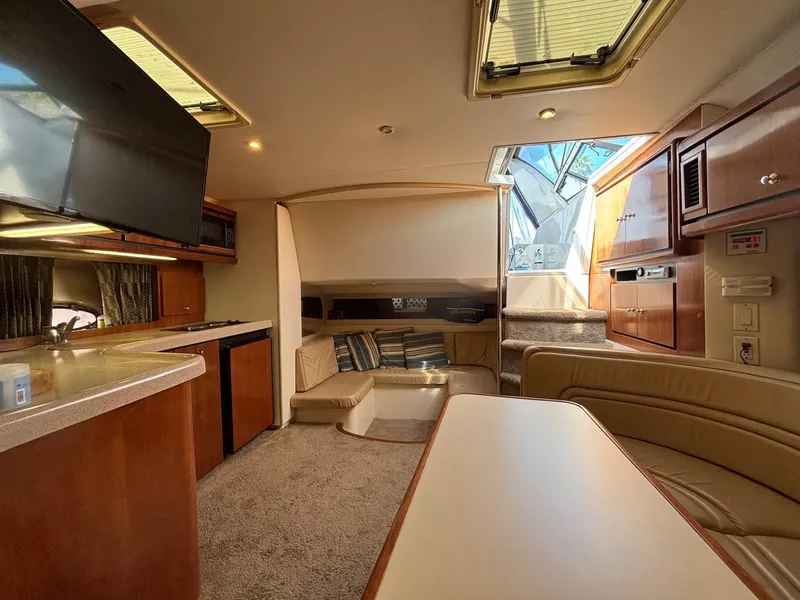 Slide: The Image of Luxurious interior of a 1998 Trojan 400 yacht with modern amenities and comfortable seating. - 15