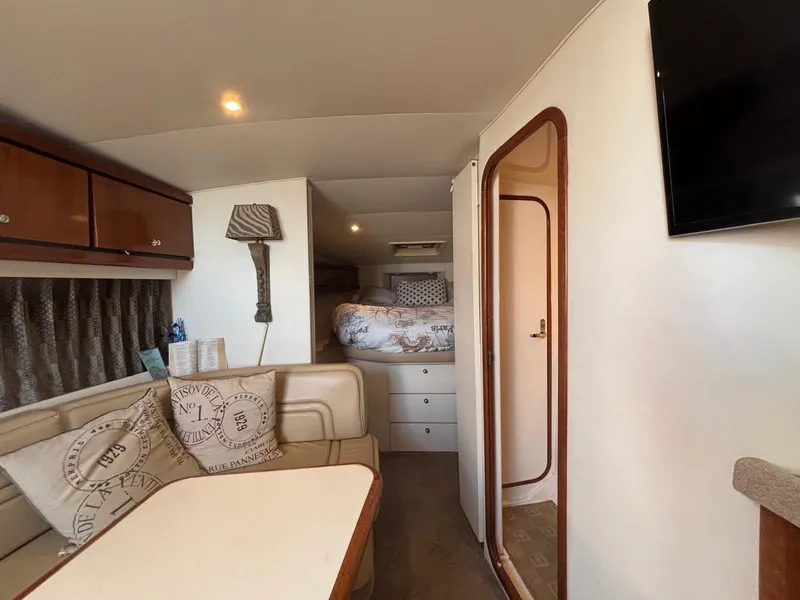 Slide: The Image of 1998 Trojan 400 yacht interior with cozy seating, bed, and modern amenities. - 18