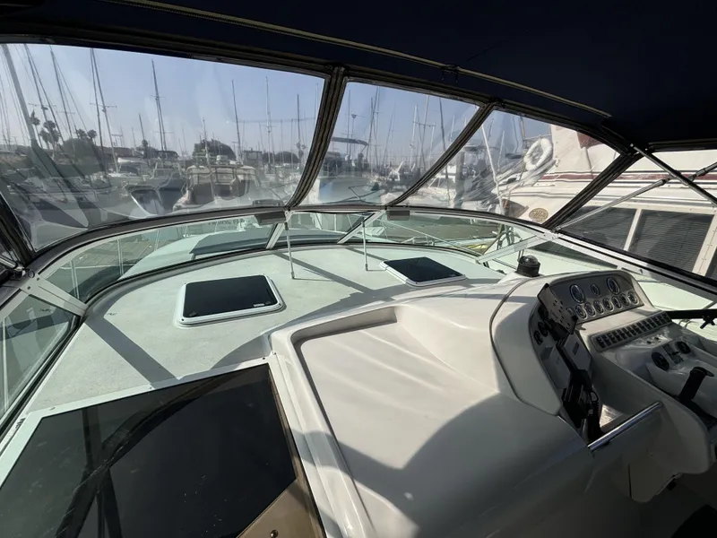 Slide: The Image of Cockpit view of a 1998 Trojan 400 boat docked in a marina. - 4