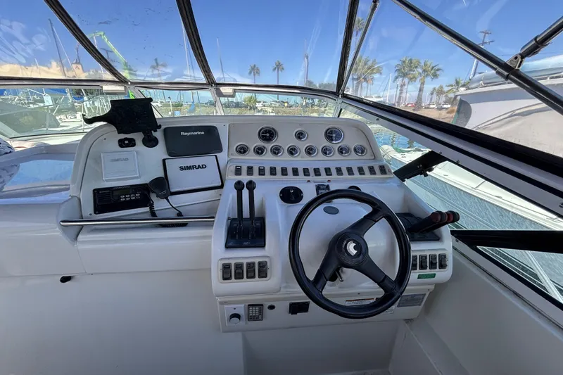 Slide: The Image of 1998 Trojan 400 boat cockpit with steering wheel, controls, and navigation equipment. - 6