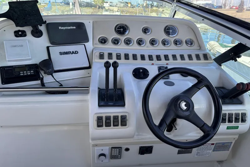 Slide: The Image of Cockpit of a 1998 Trojan 400 boat with steering wheel and navigation controls. - 7