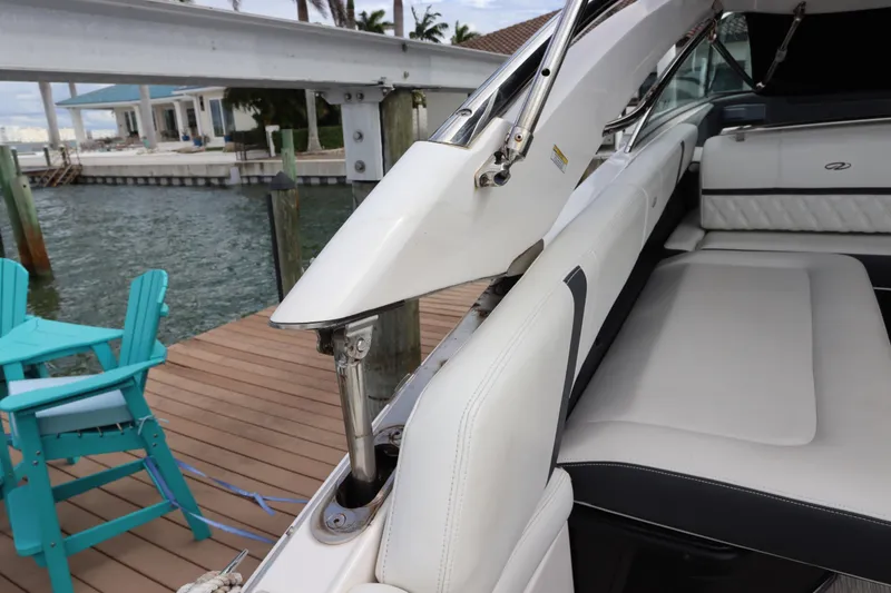 Slide: The Image of 2018 Regal 29 OBX boat interior with white seating and hydraulic mechanism. - 14
