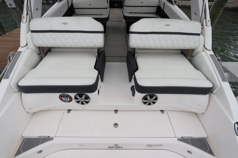 Slide: The Image of 2018 Regal 29 OBX boat interior with white cushioned seating and speaker system. - 15