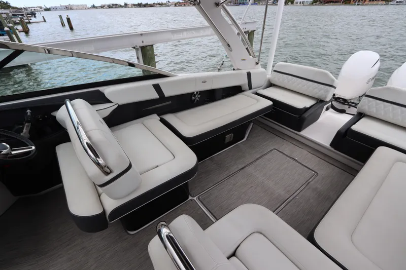 Slide: The Image of 2018 Regal 29 OBX boat interior with luxurious seating and waterfront view. - 17