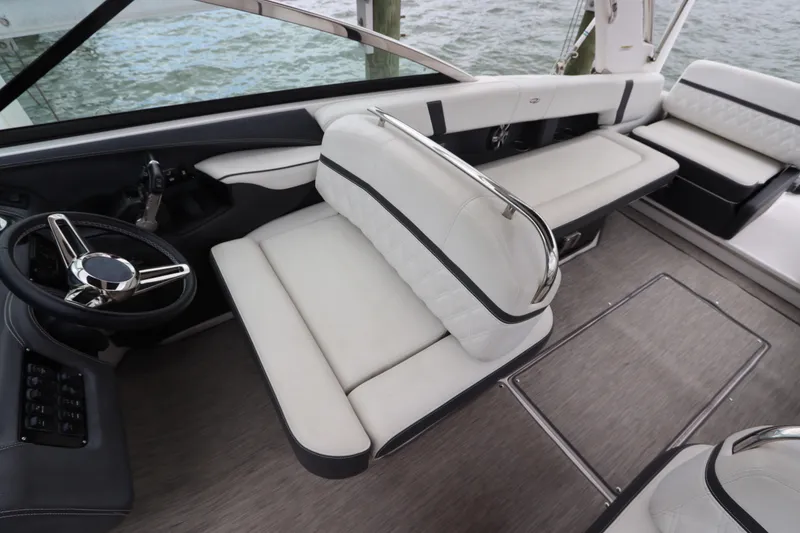 Slide: The Image of Luxurious interior of 2018 Regal 29 OBX boat with plush seating and sleek steering wheel. - 22