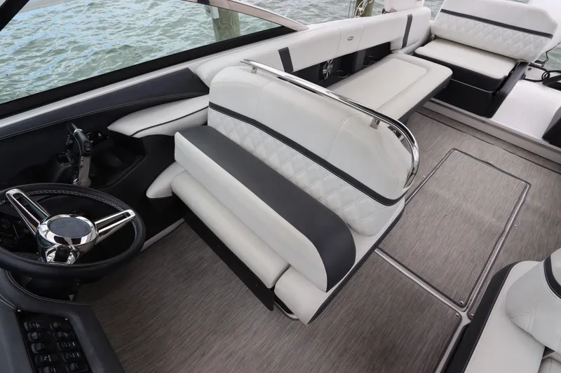 Slide: The Image of 2018 Regal 29 OBX boat interior with luxurious seating and steering wheel. - 23