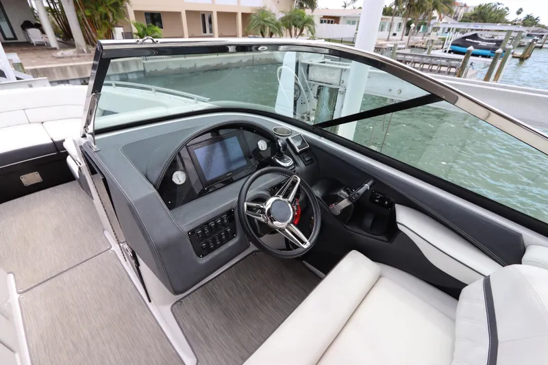 Slide: The Image of 2018 Regal 29 OBX boat cockpit with modern steering and control panel. - 24