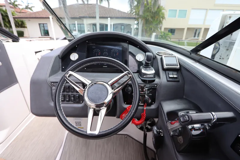 Slide: The Image of 2018 Regal 29 OBX boat dashboard with steering wheel and control panel. - 25