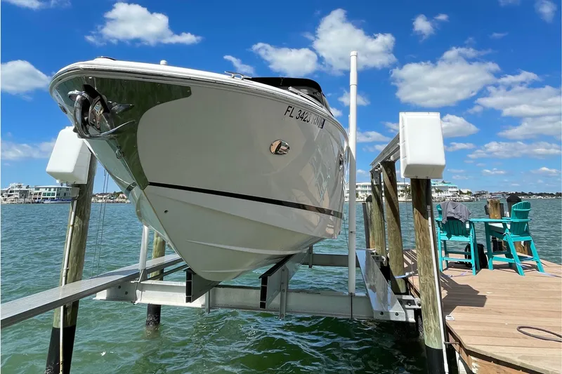 Slide: The Image of 2018 Regal 29 OBX boat on lift at dock, sunny day, blue sky. - 3
