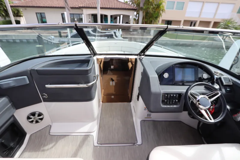 Slide: The Image of 2018 Regal 29 OBX boat interior with modern dashboard and steering wheel. - 32